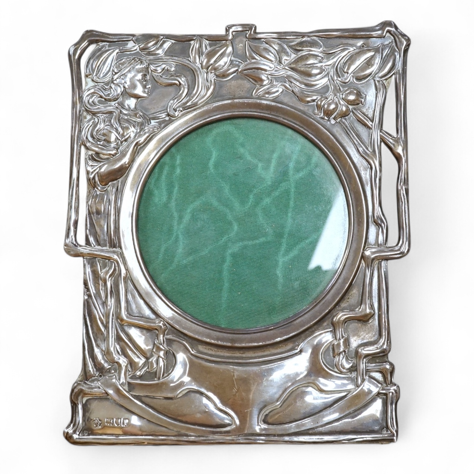 An Edwardian Art Nouveau silver mounted shaped rectangular photograph frame, by William Hutton & Sons, London 1901, decorated with a maiden amongst foliage, 19.5cm.
